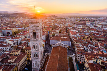 Wall Mural - The bell tower Giotto's Campanile with the rooftop of Santa Maria del Fiore Duomo in Florence during beautiful sunset.