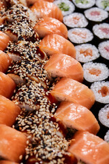 Wall Mural - Large set with rows of different types of sushi rolls with different fillings.