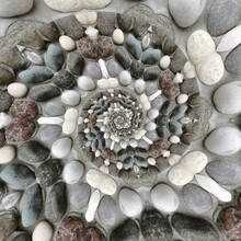 Pebble Patterns From Many Grey And White Smooth Stones Arranged To Form Creative Spiral Designs