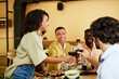 © chika_milan - Friends are toasting with red wine in a restaurant during the dinner.