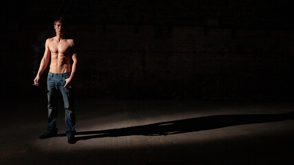 Wall Mural - Shadowplay. Series of images of casually dressed models in a dark and industrial setting experimenting with light.