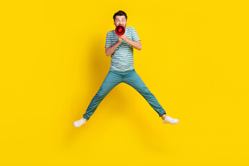 Poster - Full length photo of crazy man student dressed striped t-shirt blue trousers screaming in loudspeaker isolated on yellow color background