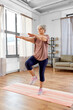 © Syda Productions - sport, fitness and healthy lifestyle concept - smiling senior woman exercising on mat at home