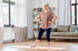 © Syda Productions - sport, fitness and healthy lifestyle concept - smiling senior woman exercising on mat at home