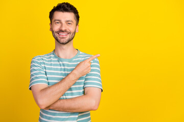 Poster - Portrait of young attractive smiling beaming guy pointing empty space good dentistry clinic isolated on yellow color background