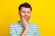 © deagreez - Photo of sick guy hand cheek wear striped t-shirt isolated on yellow color background