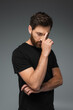 © LIGHTFIELD STUDIOS - portrait of thoughtful man in black t-shirt with closed eyes isolated on grey.