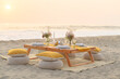 © ADDICTIVE STOCK - Small wooden decorated table placed on sandy seashore before romantic dinner