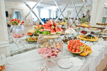 Wall Mural - Beautiful wedding candy bar with sweets, fruits and food. Wedding banquet table