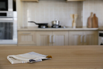 Stylish wooden kitchen with built-in appliances and small beige tile. Close up, copy space, background.