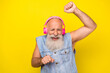 © deagreez - Photo of funky cool man pensioner dressed denim vest headphones having fun isolated yellow color background