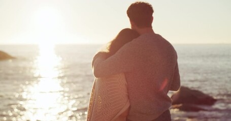 Canvas Print - Husband and wife celebrating an anniversary, hugging and looking at the view of the sea on romantic holiday. Couple watching the sunset, drinking wine and bonding at the beach in nature from behind.