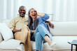 © oneinchpunch - cinematic image of an happy multiethnic senior couple. Indoors Lifestyle moments at home. Concept about seniority and relationships
