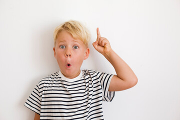 blondie cheerful 6 years old boy over white background