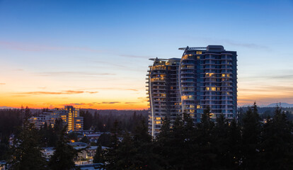 Wall Mural - Aerial View of a New Residential Property Building. Modern Architectural Design in a suburban city. White Rock, Vancouver, British Columbia, Canada. Sunset Sky