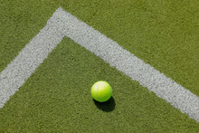 Tennis Ball With White Lines, Like A Corner, On Green Grass Tennis Court, No Person