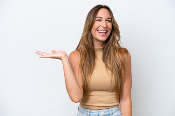 Wall Mural - Young caucasian woman isolated on white background holding copyspace imaginary on the palm to insert an ad