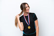 © luismolinero - Young caucasian woman with medals isolated on white background thinking an idea
