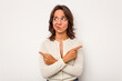 © Asier - Young hispanic woman isolated on white background points sideways, is trying to choose between two options.