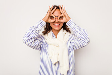 Wall Mural - Young hispanic woman isolated on white background excited keeping ok gesture on eye.