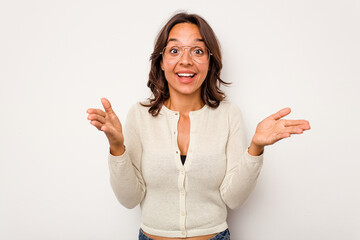 Wall Mural - Young hispanic woman isolated on white background celebrating a victory or success, he is surprised and shocked.