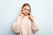 © Asier - Young caucasian girl isolated on blue background crying, unhappy with something, agony and confusion concept.