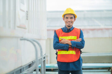 Wall Mural - Confident Asian engineer standing in  factory , Asia worker employee in hard hat safety work in factory