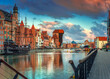 Leinwandbild Motiv Old town in Gdansk with historical port crane over Motlawa river at sunrise, Poland.