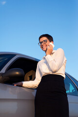 Woman talking on the smart phone during business travel on a sunny summer day