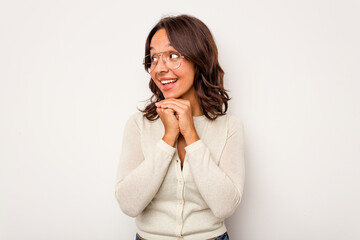 Wall Mural - Young hispanic woman isolated on white background praying for luck, amazed and opening mouth looking to front.