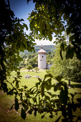 Canvas Print - Beautiful, round medieval tower of Dreznik fortress, rising on the cliff above Korana river canyon in the woods, near town of Rakovica, Croatia