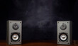 Two audio speakers with smoky background music related banner