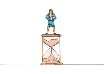 Poster - Single one line drawing of young business woman standing above hourglass. Sandglass to show time management business minimalist concept. Modern continuous line draw design graphic vector illustration.