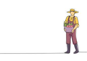 Poster - continuous one line drawing young male farmer carrying a basket full of fruit with his hands in fron