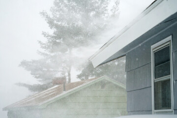 Poster - strong wind blowing snow off the roof in blizzard