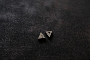 The letters A and V above the dark field. Initials AV.