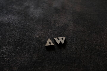 Wall Mural - The letters A and W above the dark field. Initials AW.