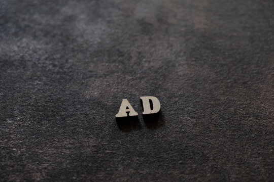 The letters A and D above the dark field. Initials AD