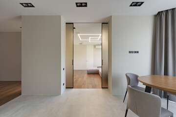 interior of bright kitchen with dining area and glass door, interior of beautiful kitchen, kitchen in a modern apartment with large glass sliding doors