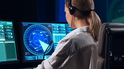 Workplace of the air traffic controllers in the control tower. Team of professional aircraft control officers works using radar, computer navigation and digital maps. Aviation concept.