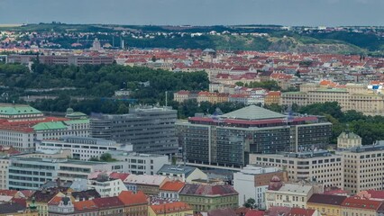 Wall Mural - Panoramic view of Prague timelapse from the top of the Vitkov Memorial, Czech Republic. Old Town with red roofs and modern buildings. Cloudy sky at summer day