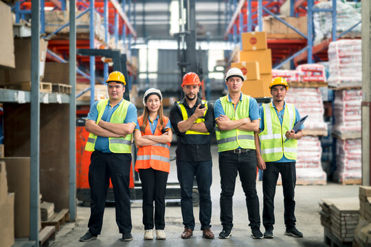 Group worker factory or engineer men and women standing with confidence and success. people working in workplace of warehouse industrial factory. young adult in career of industry of warehouse.