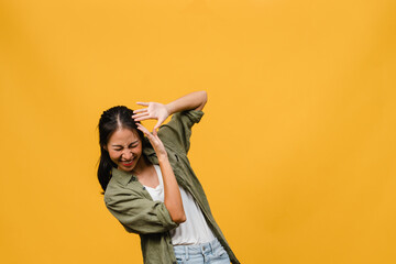 Wall Mural - Portrait of young Asia lady with positive expression, smile broadly, dressed in casual clothing over yellow background. Happy adorable glad woman rejoices success. Facial expression concept.