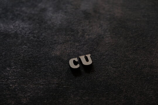 The letters C and U above the dark field. Initials CU