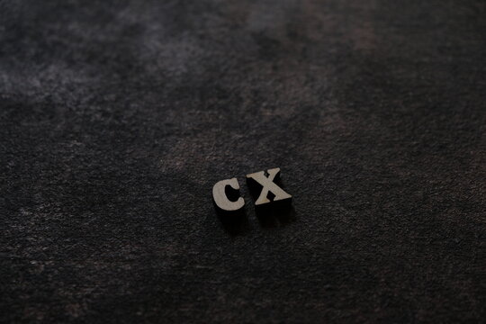 The letters C and X above the dark field. Initials CX