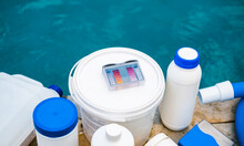 High Angle View Of Equipment For Testing The Quality Of Pool Water And Chemical Cleaning Products At The Edge Of Swimming Pool