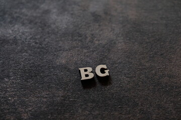 Wall Mural - the letters b and g above the dark field. initials bg