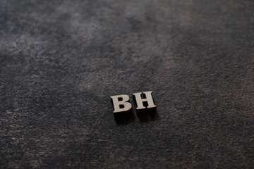 Wall Mural - the letters b and h above the dark field. initials bh