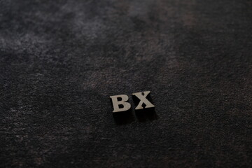 Wall Mural - the letters b and x above the dark field. initials bx