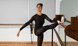 © Paulina - young ballet dancer stretching at a dance studio
